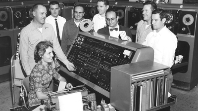 Computer scientists standing around univac computer in 1959