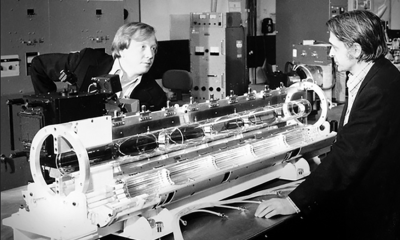 Two people in the lab conducting an experiment, picture in black and white.