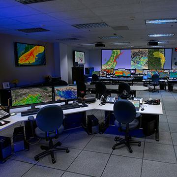 Room of computer screens and stations with monitoring data