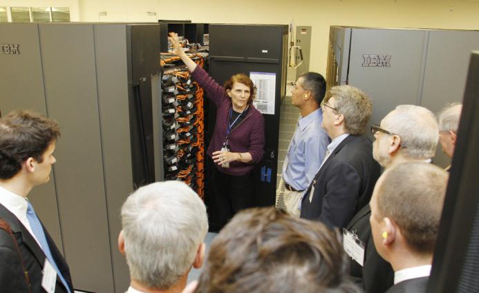 Terri Quinn showing supercomputer to visitors