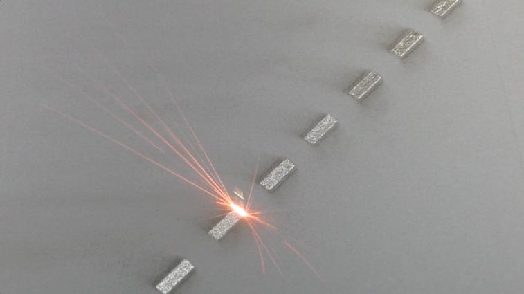 Direct metal laser melting (DMLM) machine in action