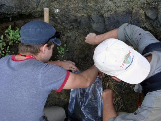 A zoom-in of LLNL colleagues Blair Schoene (left) and Michael Eddy, sampling a volcanic ash-bed between two basaltic lava flows.