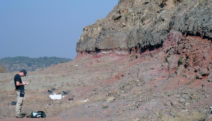 This is a representative outcropping of what many of the team’s sampling locations look like in theDeccan Traps region of India. The red band in the rock outcropping is what is informally termed a “red bole”, essentially an ancient soil developed during a hiatus in volcanism between the underlying (older) lava flow and overlying (younger) lava flow. 